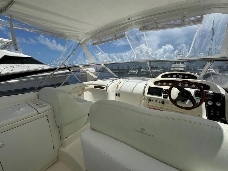 Slide: The Image of 2003 Cranchi Endurance 39 yacht interior with helm, white seating, and clear canopy. - 6