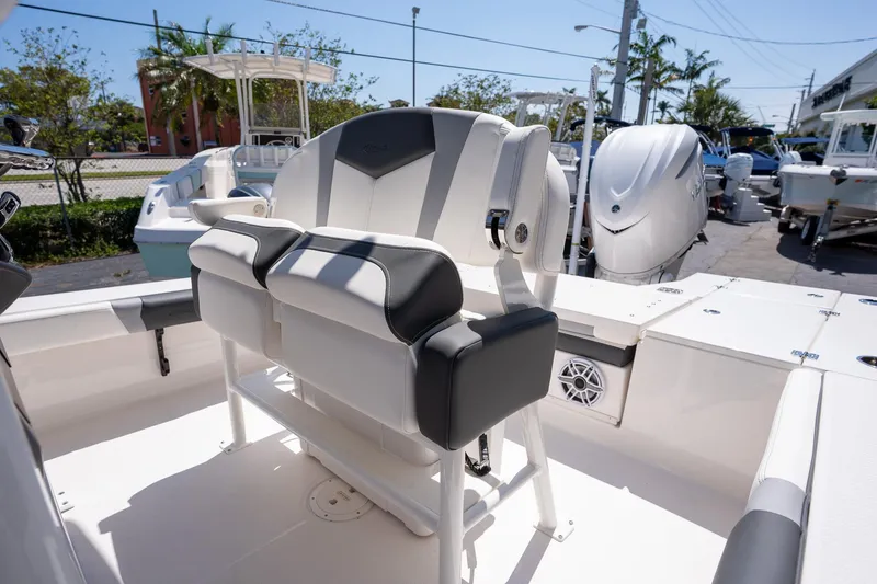 Slide: The Image of 2025 Robalo R246 CAYMAN boat interior with cushioned seating and modern design. - 12