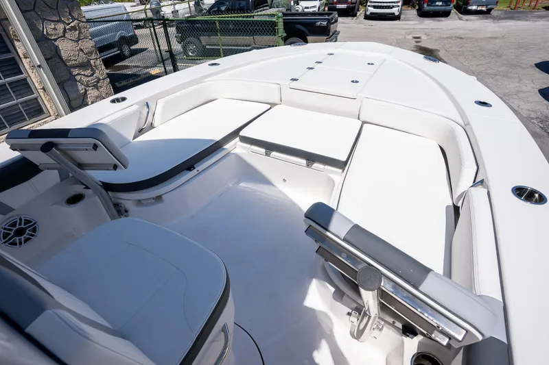 Slide: The Image of 2025 Robalo R246 CAYMAN boat interior with white seating and modern design. - 14