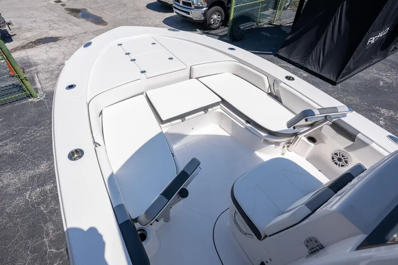 Slide: The Image of 2025 Robalo R246 CAYMAN boat interior with white seating and storage compartments. - 15