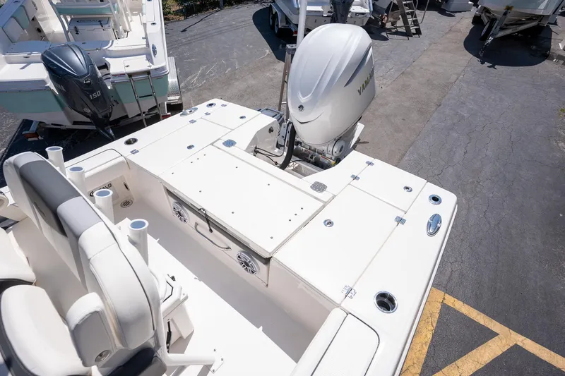 Slide: The Image of 2025 Robalo R246 CAYMAN boat with Yamaha outboard motor, docked on asphalt. - 16