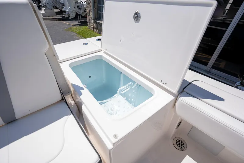 Slide: The Image of Open storage compartment on 2025 Robalo R246 CAYMAN boat, showcasing interior design. - 18