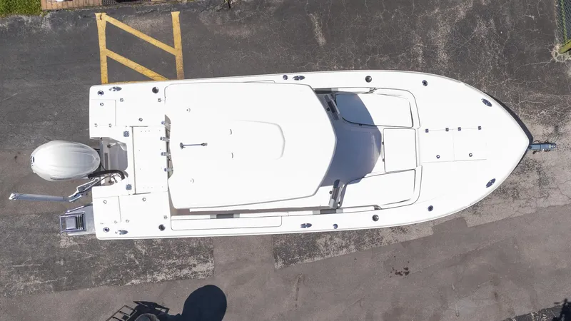 Slide: The Image of Overhead view of 2025 Robalo R246 CAYMAN boat on pavement. - 20