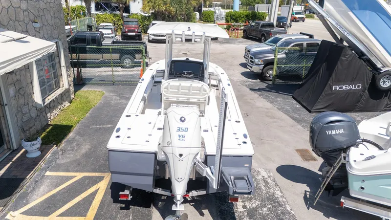 Slide: The Image of 2025 Robalo R246 CAYMAN boat with Yamaha 350 V6 engine in a dealership lot. - 6