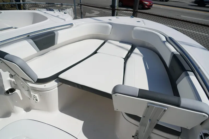 Slide: The Image of 2025 Robalo R200 boat interior with white cushioned seating and sleek design. - 12