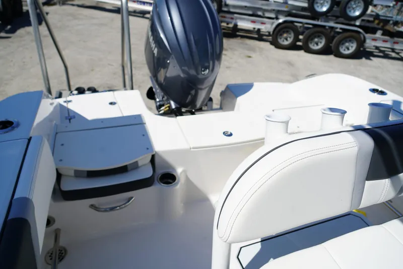 Slide: The Image of 2025 Robalo R200 boat interior with engine and seating area. - 13