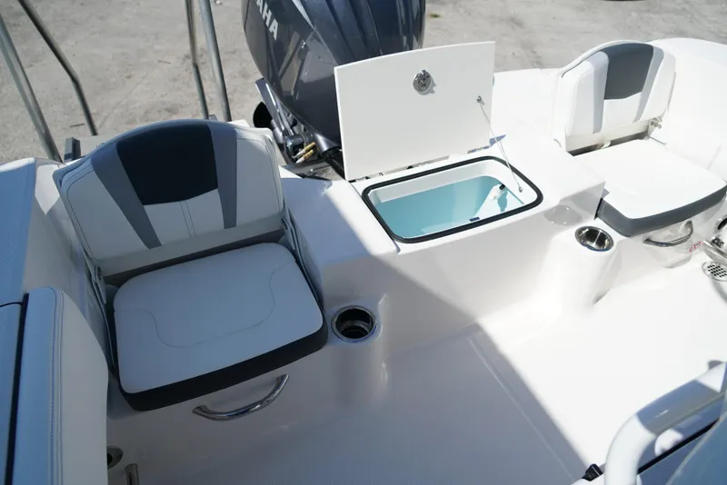 Slide: The Image of 2025 Robalo R200 boat interior with seating, storage, and Yamaha engine. - 15