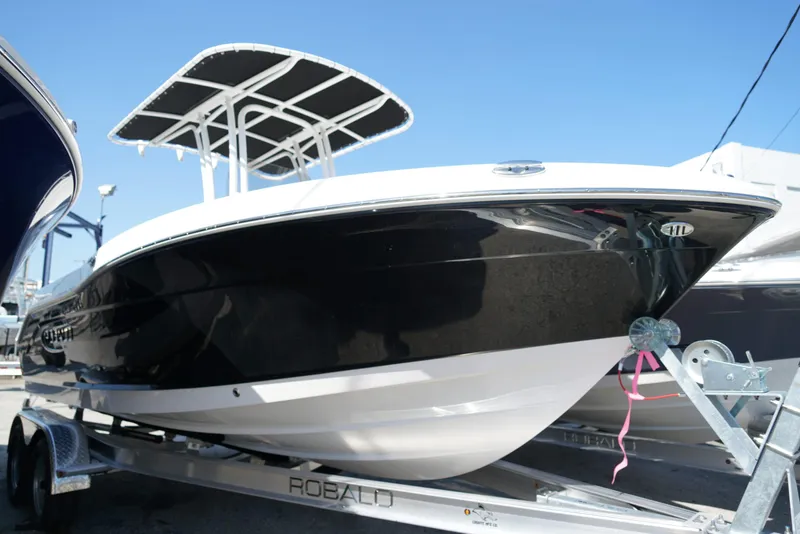 Slide: The Image of 2025 Robalo R200 boat on trailer, black hull, T-top, sunny day. - 22