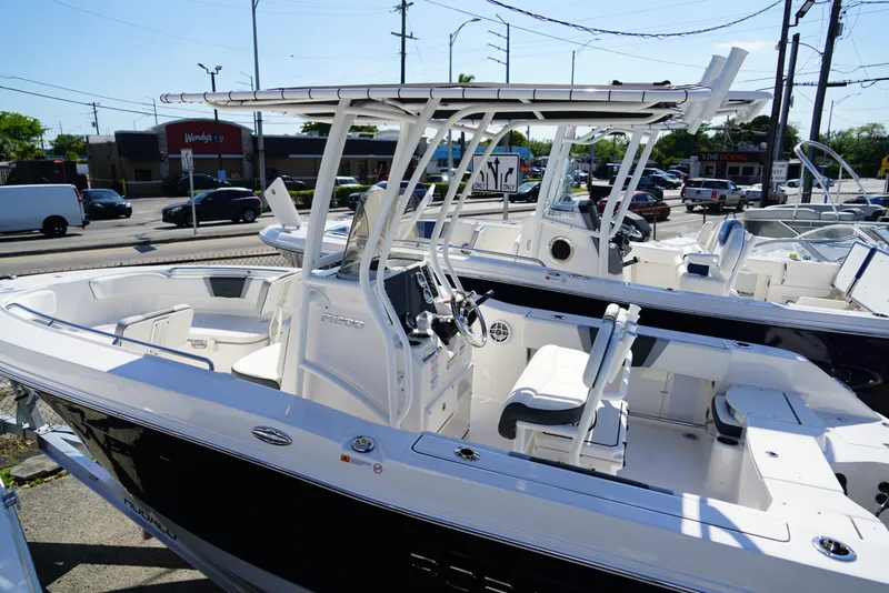 Slide: The Image of 2025 Robalo R200 boat with sleek design, parked outdoors in a dealership setting. - 23
