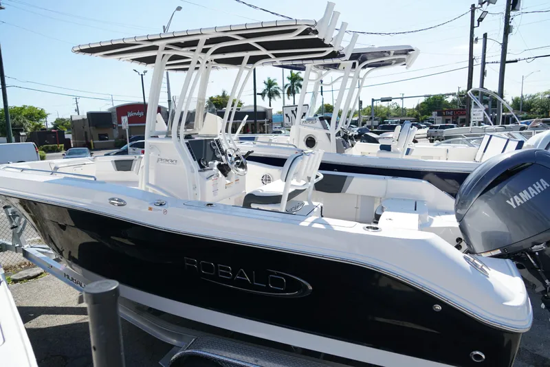 Slide: The Image of 2025 Robalo R200 boat with Yamaha engine, parked outdoors, showcasing sleek design and modern features. - 24