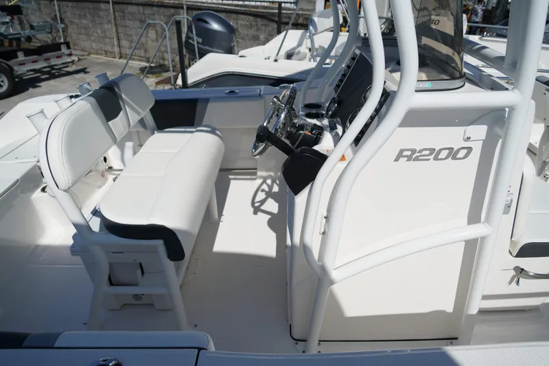 Slide: The Image of 2025 Robalo R200 boat interior with seating and steering console. - 25