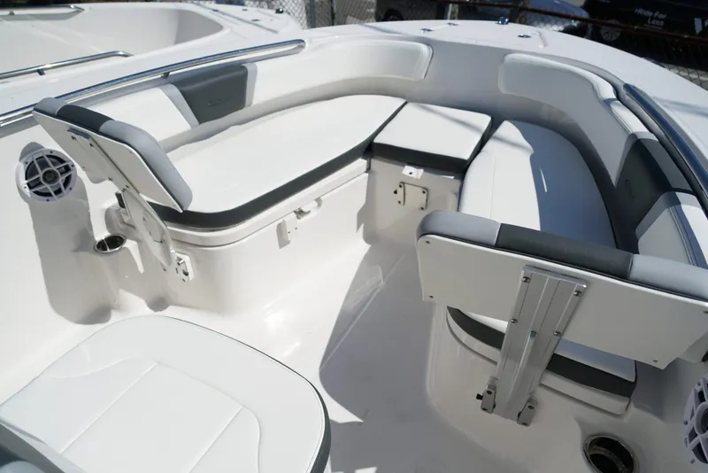 Slide: The Image of 2025 Robalo R200 boat interior with cushioned seating and stainless steel railings. - 8
