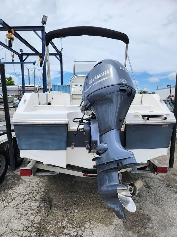 Slide: The Image of 2020 Robalo R180 boat with Yamaha outboard motor, docked on a trailer. - 10