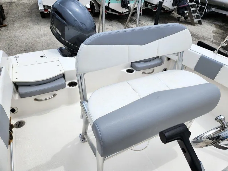 Slide: The Image of 2020 Robalo R180 boat interior with seating and Yamaha outboard motor. - 11