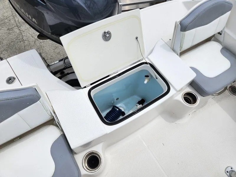 Slide: The Image of 2020 Robalo R180 boat interior with open storage compartment and seating. - 12