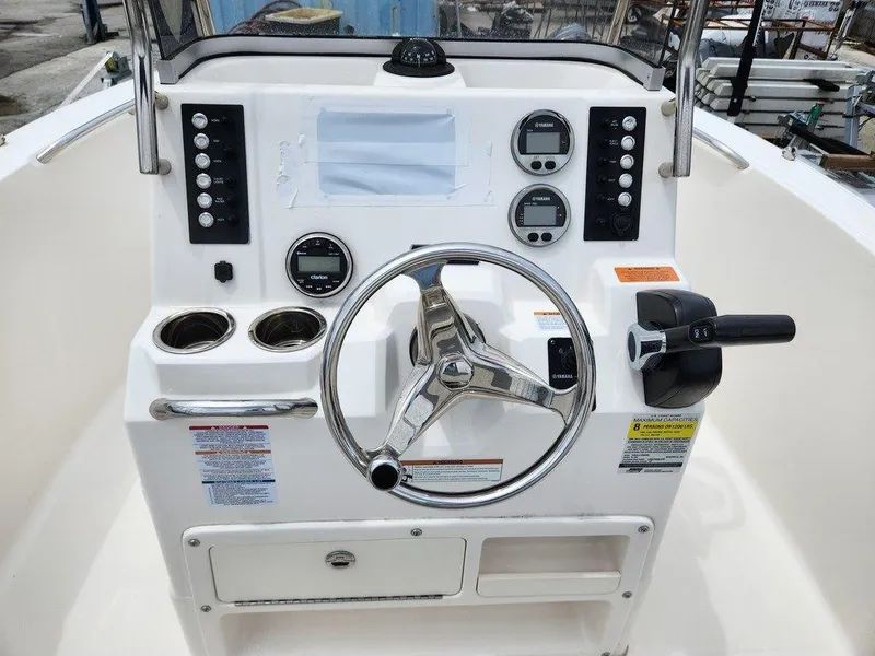 Slide: The Image of 2020 Robalo R180 boat dashboard with steering wheel and control panel. - 5