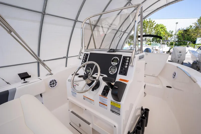 Slide: The Image of 2025 Robalo R180 boat cockpit with steering wheel and control panel. - 10
