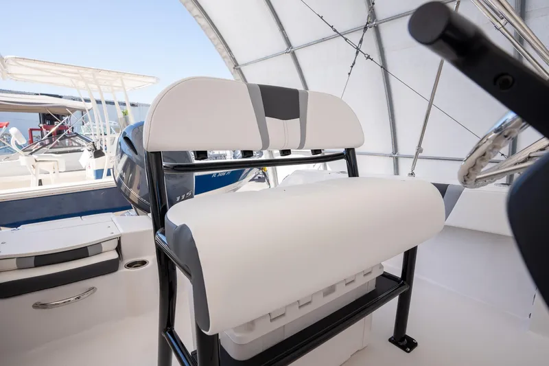 Slide: The Image of 2025 Robalo R180 boat interior with cushioned seating and steering wheel. - 12