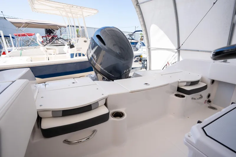Slide: The Image of 2025 Robalo R180 boat interior with Yamaha engine, featuring seating and storage compartments. - 13