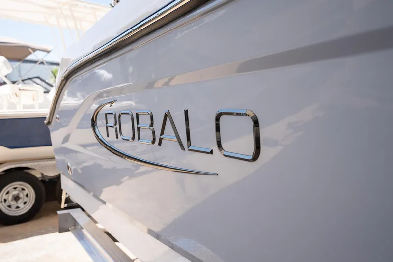 Slide: The Image of 2025 Robalo R180 boat logo close-up in sunlight. - 3