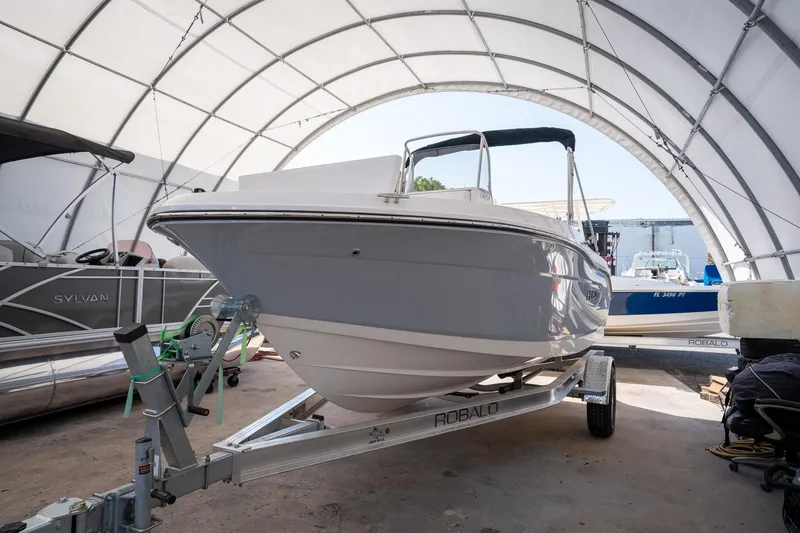Slide: The Image of 2025 Robalo R180 boat on trailer in covered storage area. - 4