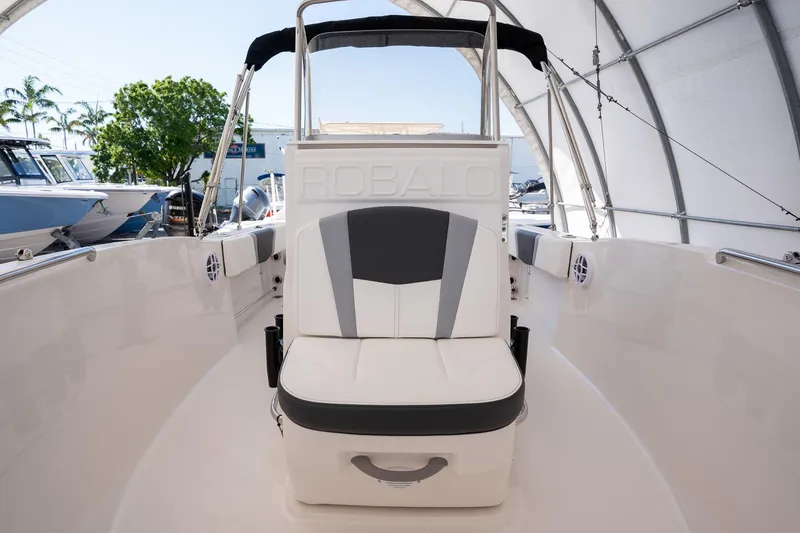 Slide: The Image of 2025 Robalo R180 boat interior with cushioned seating and sleek design. - 5