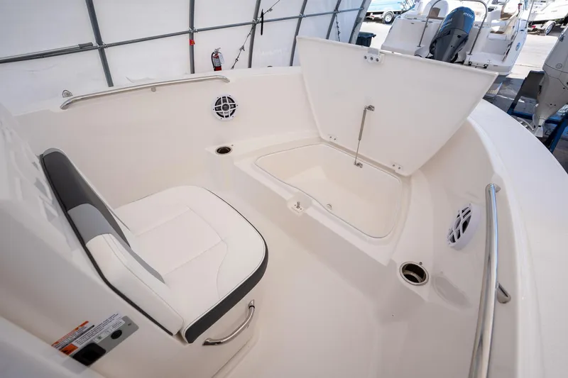 Slide: The Image of 2025 Robalo R180 boat interior with seating and storage compartment. - 7