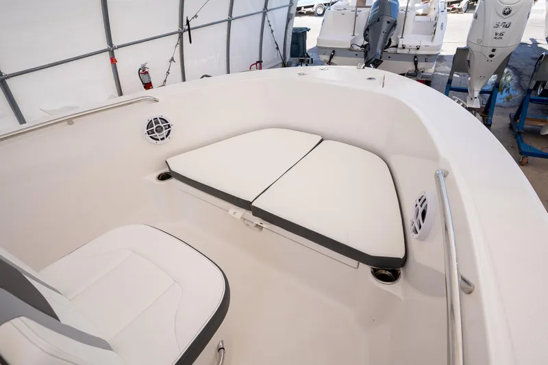 Slide: The Image of 2025 Robalo R180 boat interior with cushioned seating and modern design. - 8