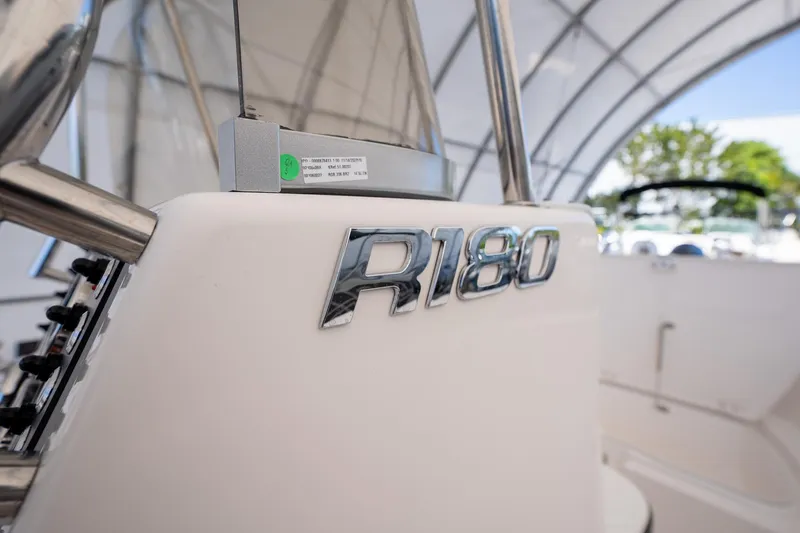 Slide: The Image of 2025 Robalo R180 boat interior with chrome logo detail. - 9