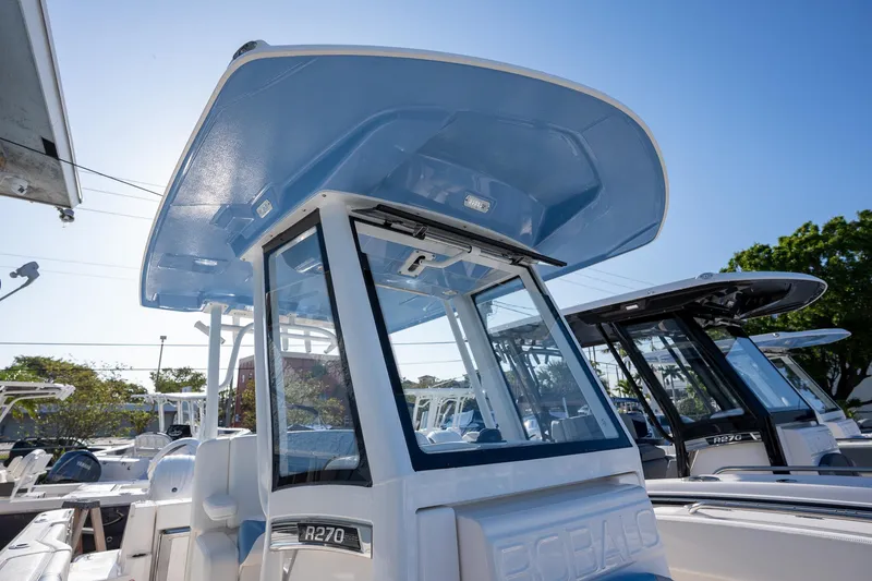 Slide: The Image of 2025 Robalo R270 boat with sleek design and modern features under clear blue sky. - 10