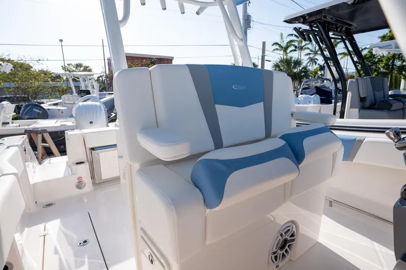 Slide: The Image of 2025 Robalo R270 boat interior with blue and white seating, showcasing modern design. - 13