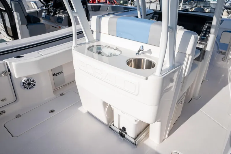 Slide: The Image of 2025 Robalo R270 boat interior with sink and seating area. - 15
