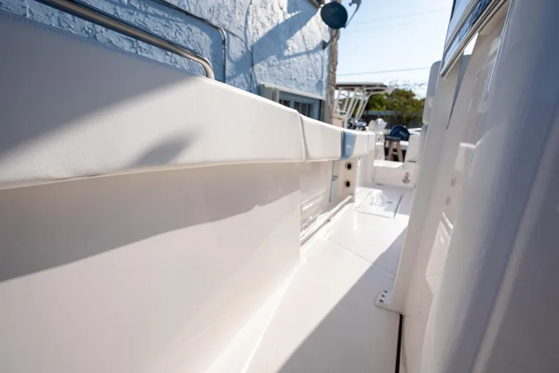 Slide: The Image of 2025 Robalo R270 boat interior, showcasing sleek white deck and modern design. - 18