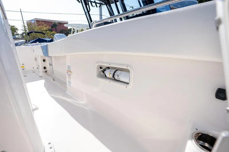 Slide: The Image of 2025 Robalo R270 boat interior with built-in fire extinguisher compartment. - 19