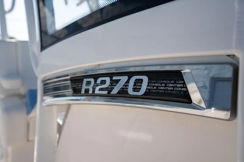 Slide: The Image of 2025 Robalo R270 boat emblem close-up, showcasing sleek design and branding. - 9