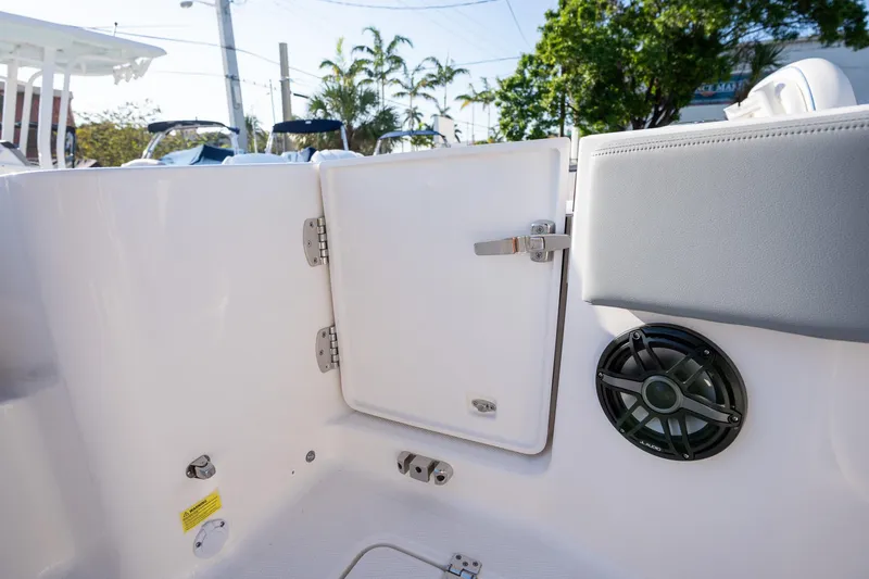 Slide: The Image of 2025 Robalo R270 boat interior with storage compartment and speaker. - 17
