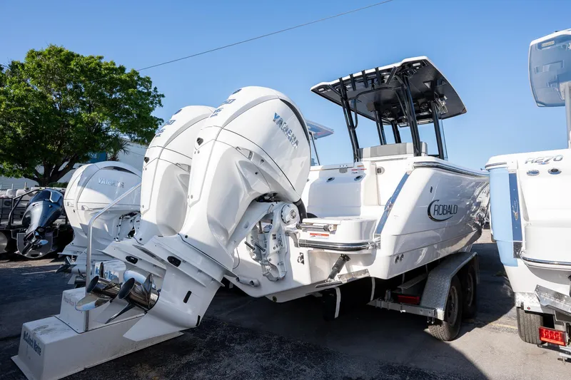 Slide: The Image of 2025 Robalo R270 boat with dual Yamaha outboard engines on a trailer. - 19