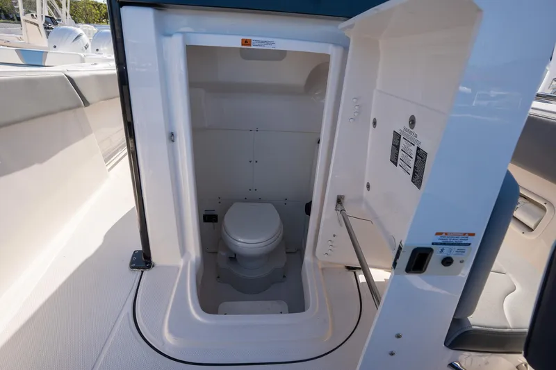 Slide: The Image of 2025 Robalo R270 boat interior with compact marine toilet. - 9