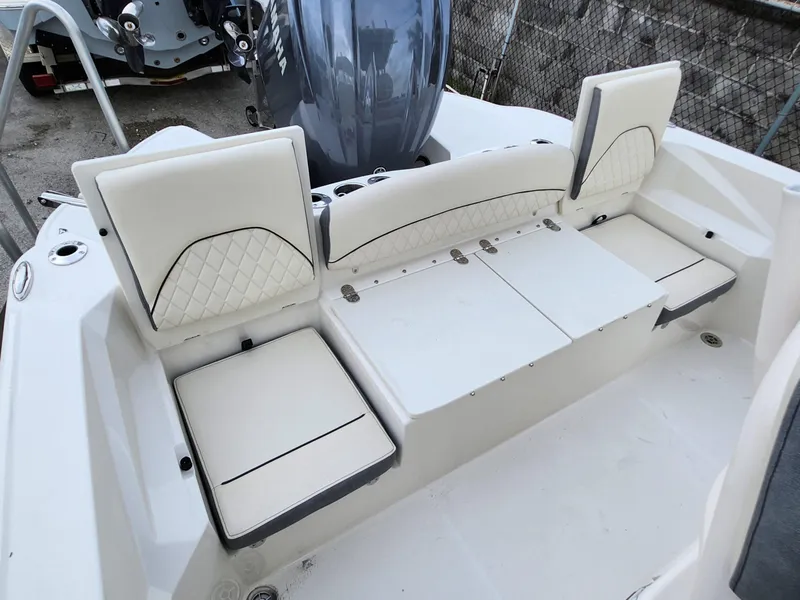 Slide: The Image of 2023 Stingray 236CC boat interior with white cushioned seating and Yamaha engine. - 14