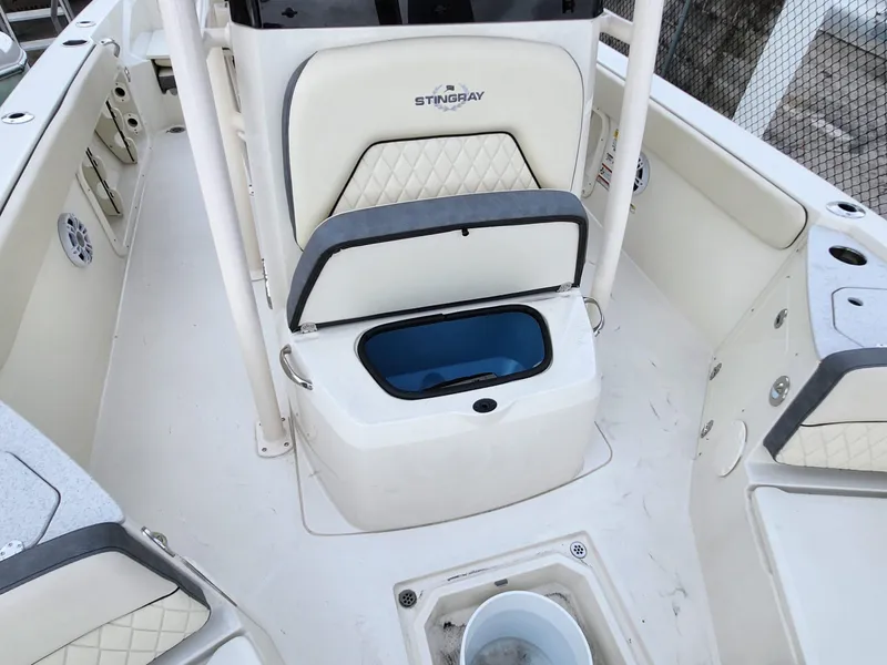 Slide: The Image of 2023 Stingray 236CC boat interior with open storage compartment and seating. - 16