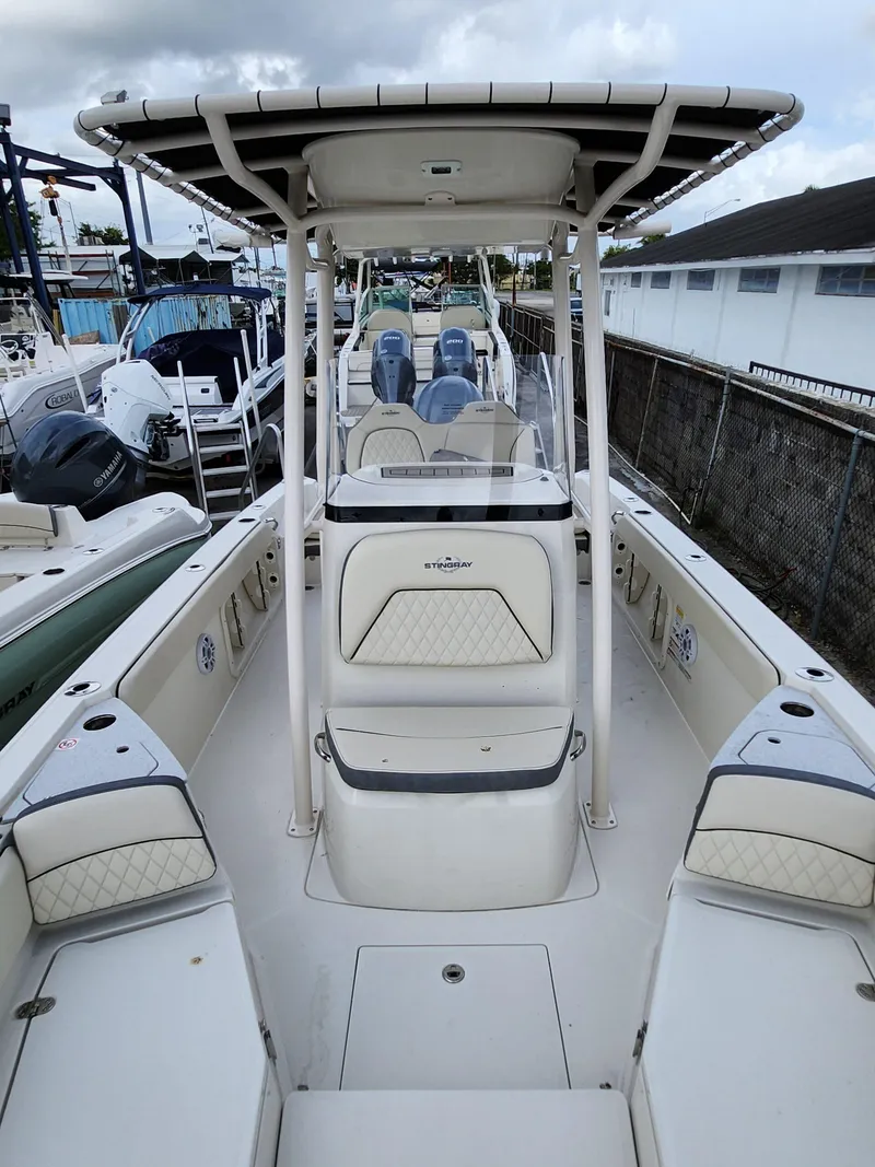 Slide: The Image of 2023 Stingray 236CC boat with T-top, spacious seating, and modern design. - 19