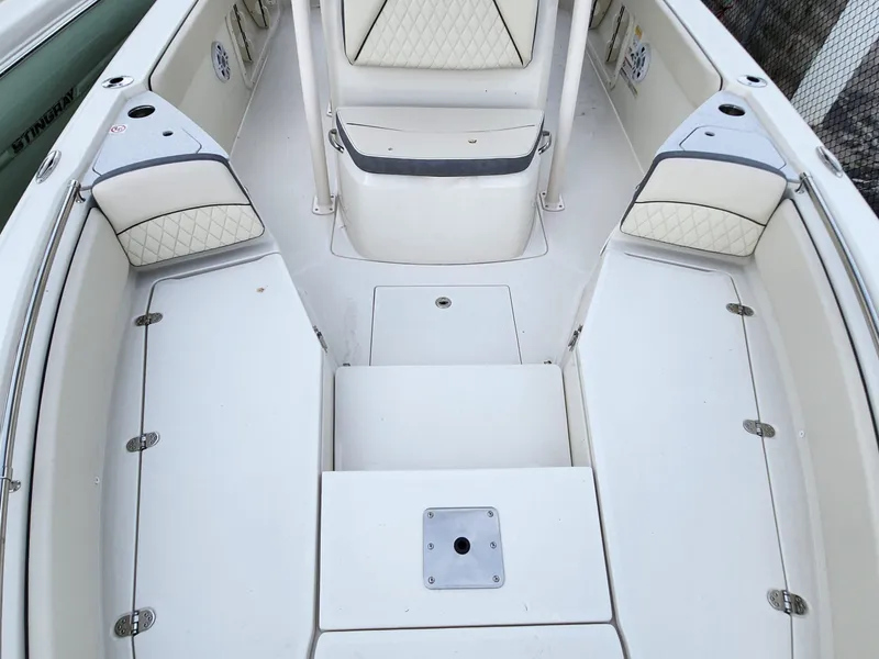 Slide: The Image of 2023 Stingray 236CC boat interior with cushioned seating and storage compartments. - 20
