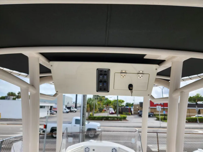 Slide: The Image of 2023 Stingray 236CC boat console with overhead panel and switches. - 25