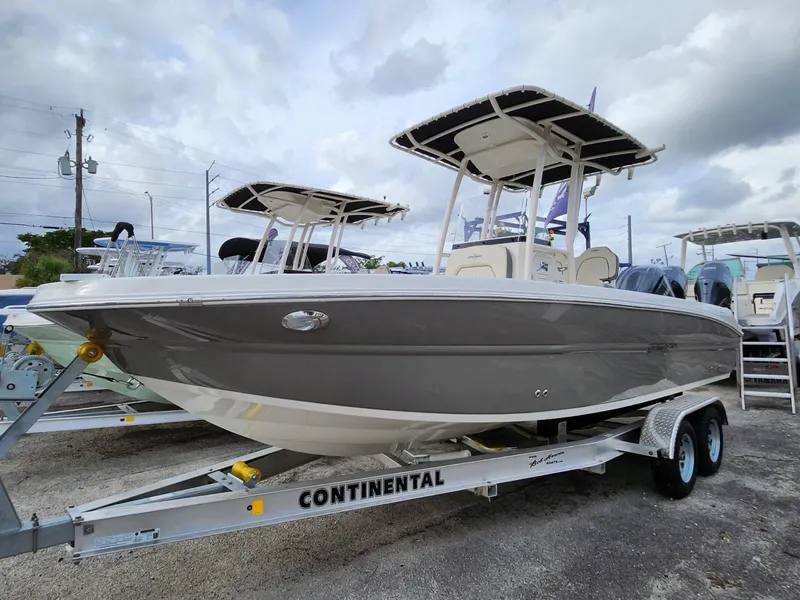 Slide: The Image of 2023 Stingray 236CC boat on trailer, displayed outdoors under cloudy sky. - 28