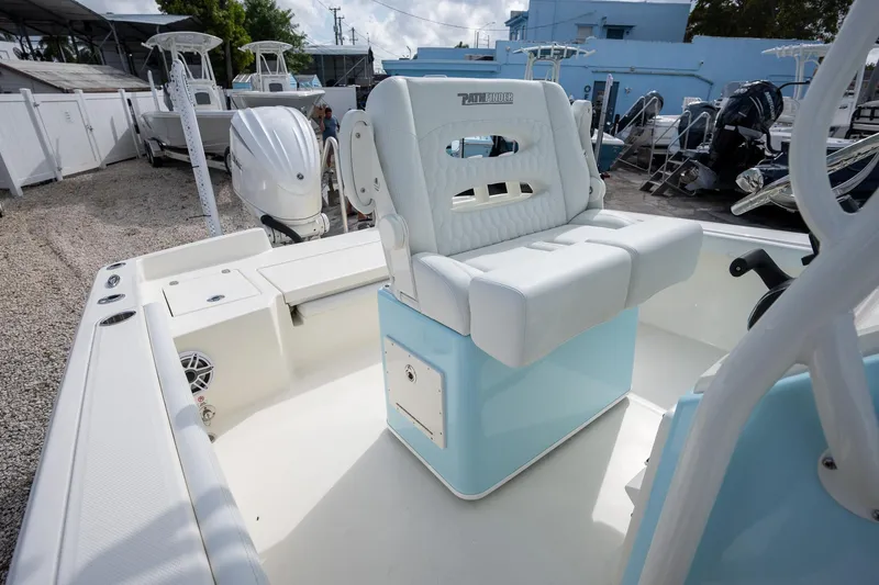 Slide: The Image of 2025 Pathfinder 2400 TRS boat interior with white seating and blue accents. - 14