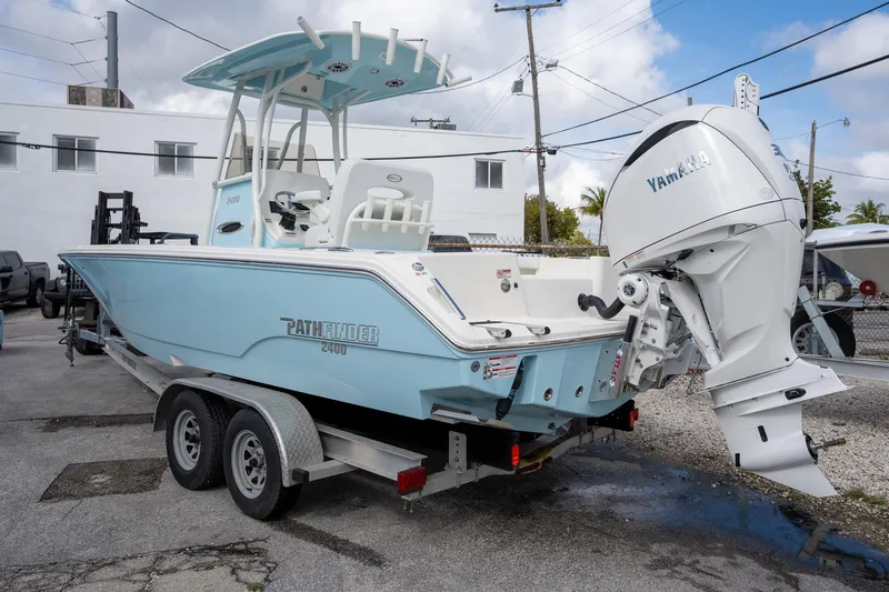 Slide: The Image of 2025 Pathfinder 2400 TRS boat on trailer with Yamaha outboard motor. - 3