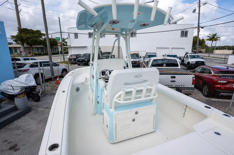 Slide: The Image of 2025 Pathfinder 2400 TRS boat with center console, parked in a lot. - 5