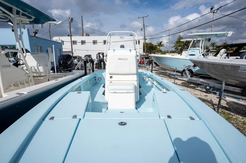 Slide: The Image of 2025 Pathfinder 2300 HPS boat displayed outdoors, surrounded by other boats. - 12