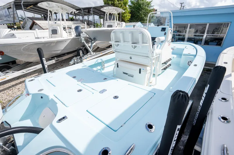 Slide: The Image of 2025 Pathfinder 2300 HPS boat in a showroom, showcasing sleek design and spacious deck. - 3