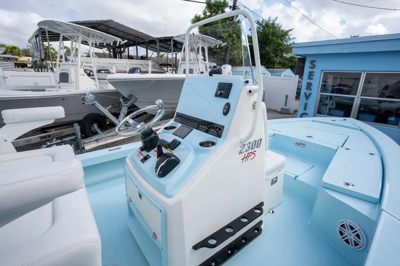 Slide: The Image of 2025 Pathfinder 2300 HPS boat interior with steering console and seating. - 5